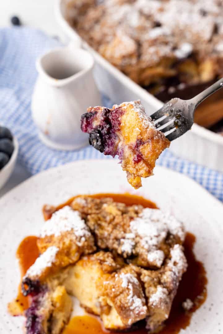 eating a bit of the casserole with a fork.