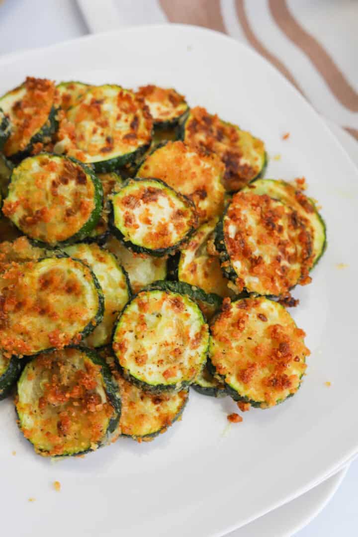 air fryer zucchini on white plates.