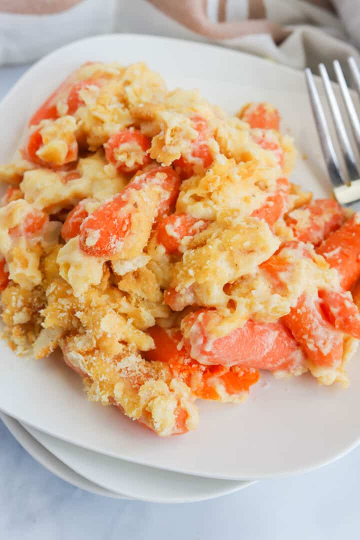 Carrot Casserole served on stacked white plates.