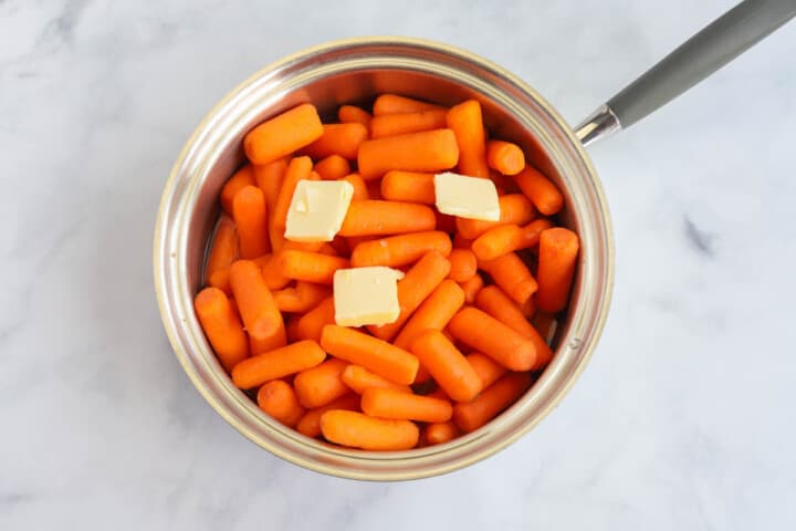carrots in pan with butter ready to cook.