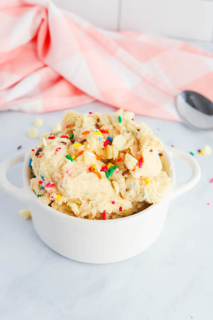 Edible Cake Batter in white bowl topped with sprinkles.