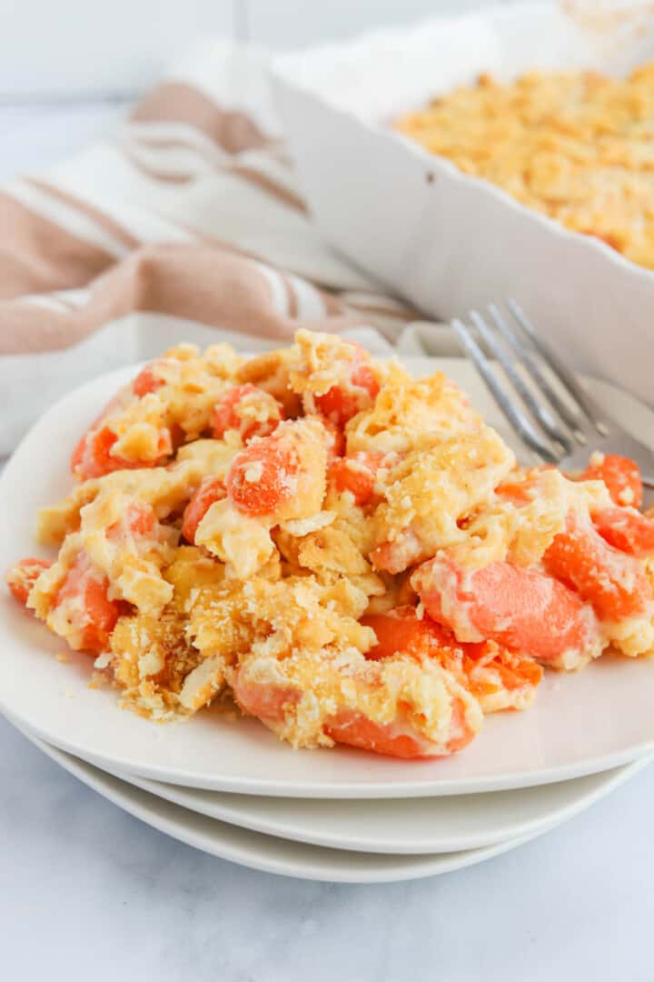 baked carrot casserole on white plates.