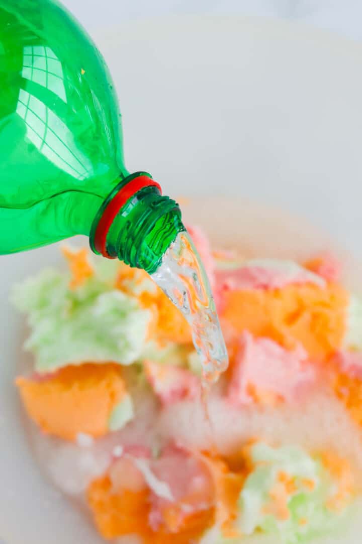 adding lemon-lime soda to the punch bowl.