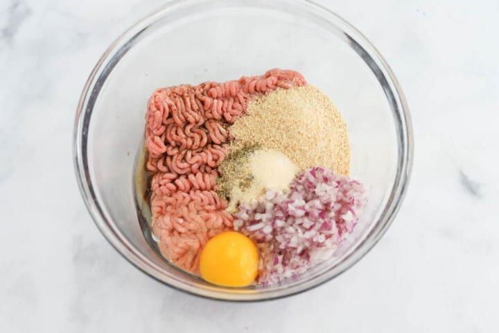 ingredients for the turkey burgers in glass mixing bowl.