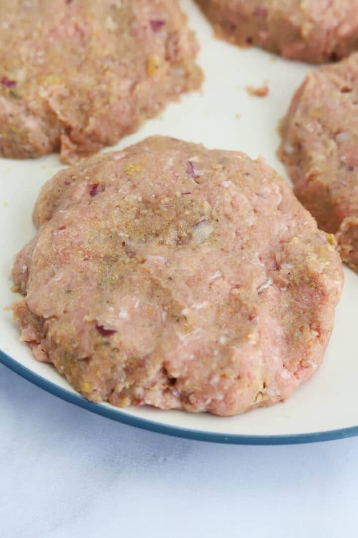 formed turkey burger patty on plate.