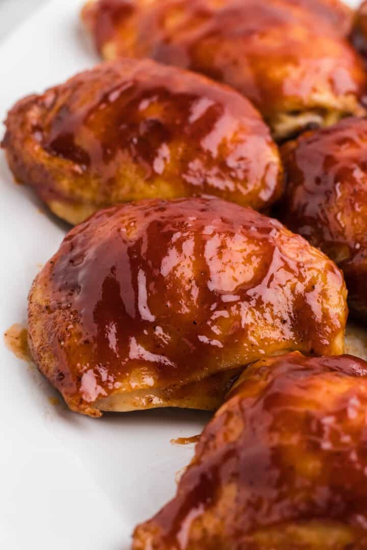 Baked BBQ Chicken Thighs on white serving tray.