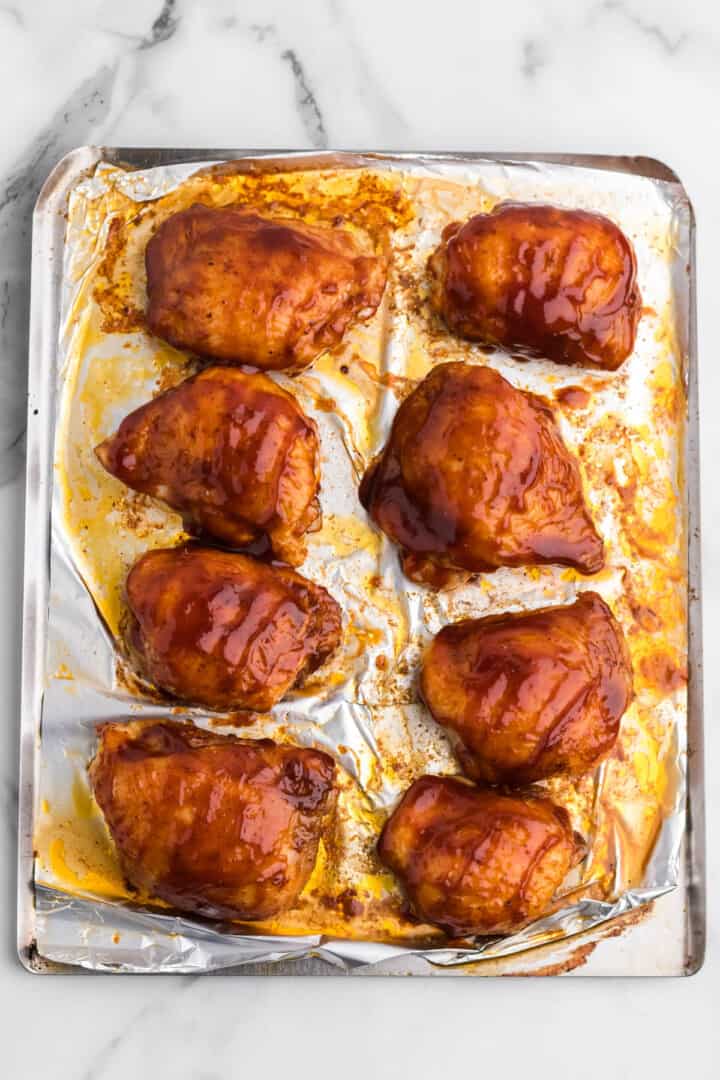 baked chicken thighs covered in BBQ sauce.