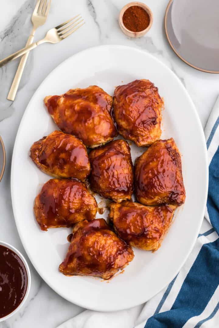 BBQ Chicken Thighs on white serving tray.
