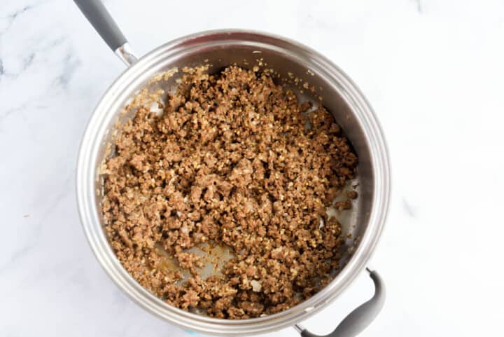 ground beef cooked in large pot.