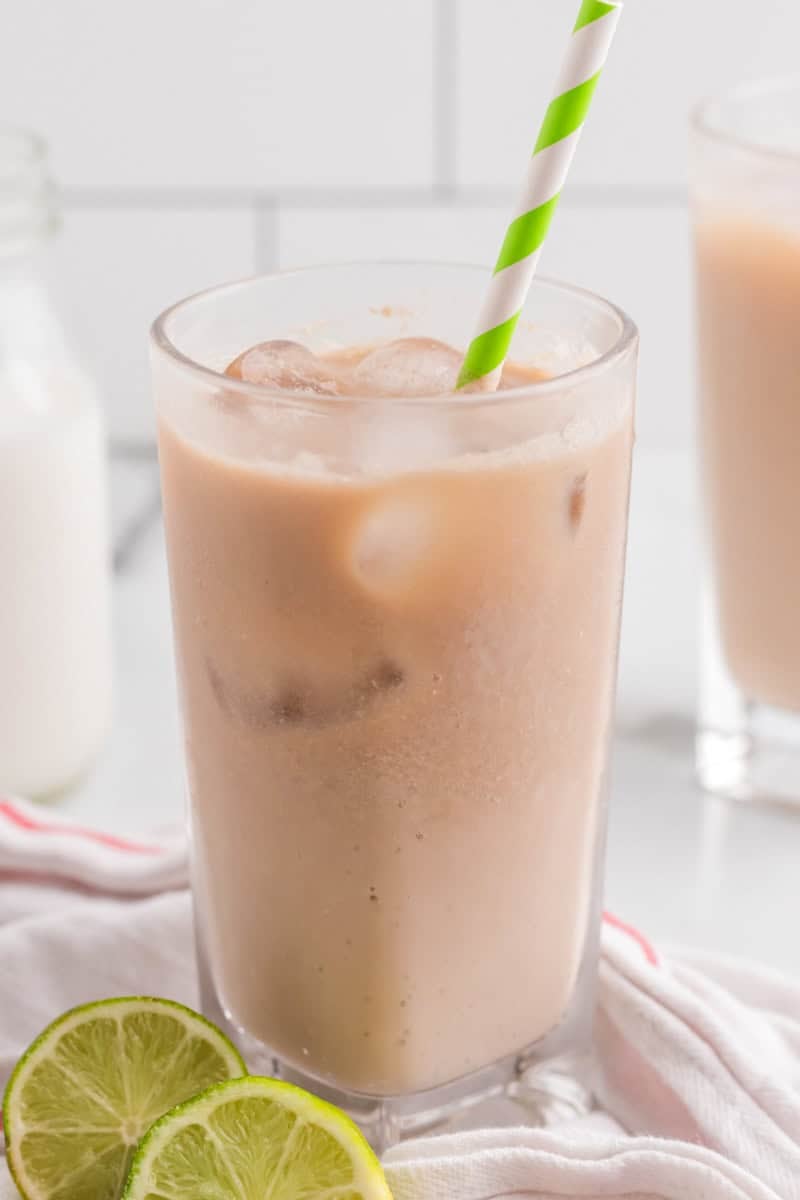 close up picture of Dirty Soda Recipe with green and white straw.