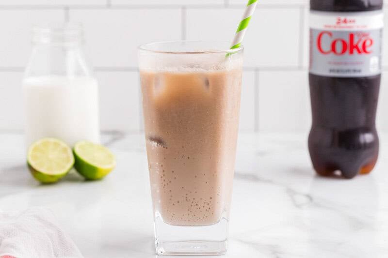 Dirty Soda Recipe in a white counter with Diet Coke and lemons in the back.