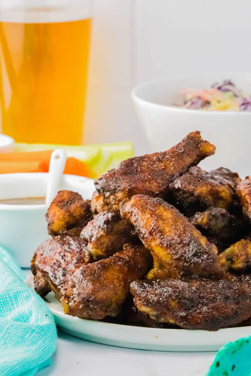 closeup of wings stacked on white plate.
