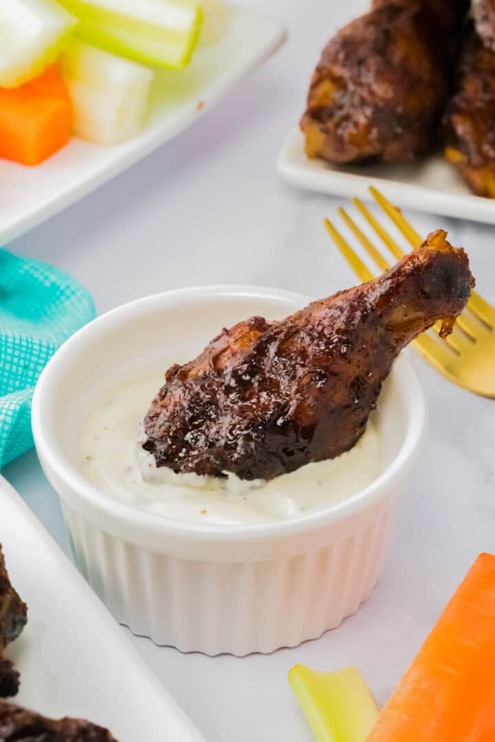 dipping a wing in ranch dressing.