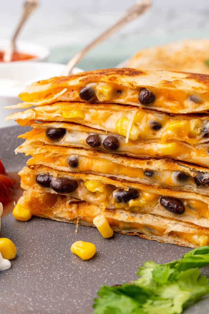 Black Bean and Cheese Quesadillas stacked on top of each other.