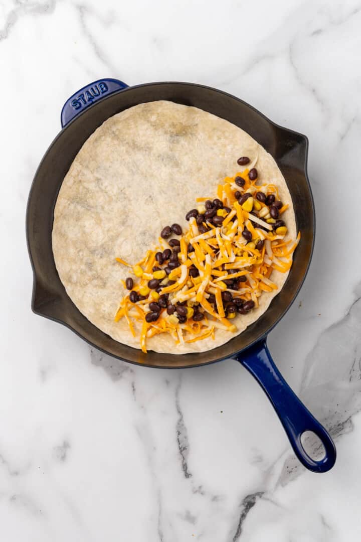making the quesadilla in a skillet.