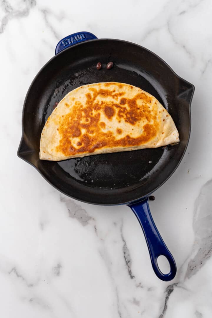 cooked quesadilla in a skillet.