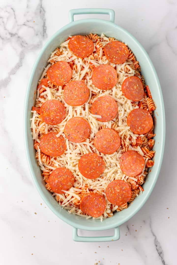 pepperoni pizza casserole spread out in casserole dish.