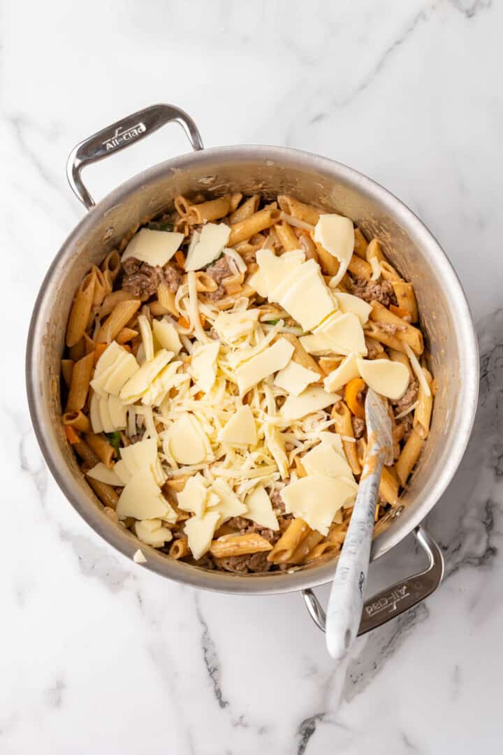 topping the pasta with the cheese.