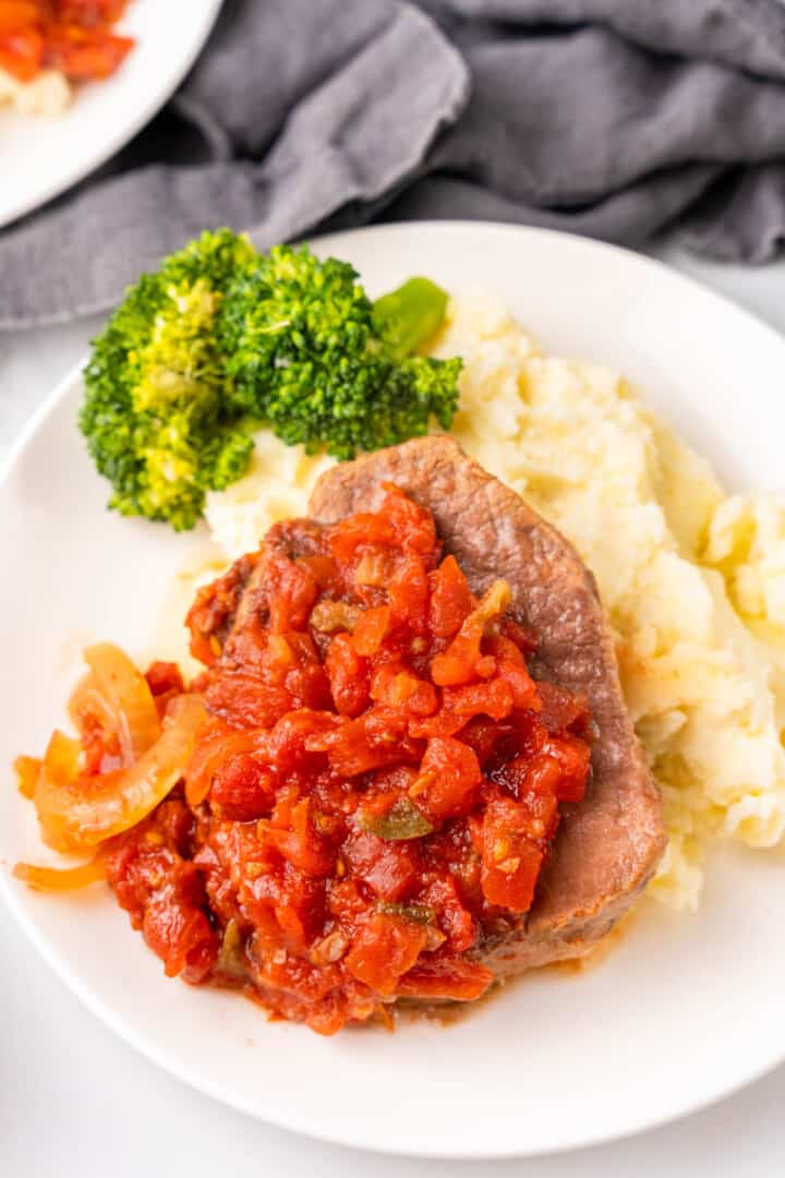 closeup of Swiss Steak on white plate.