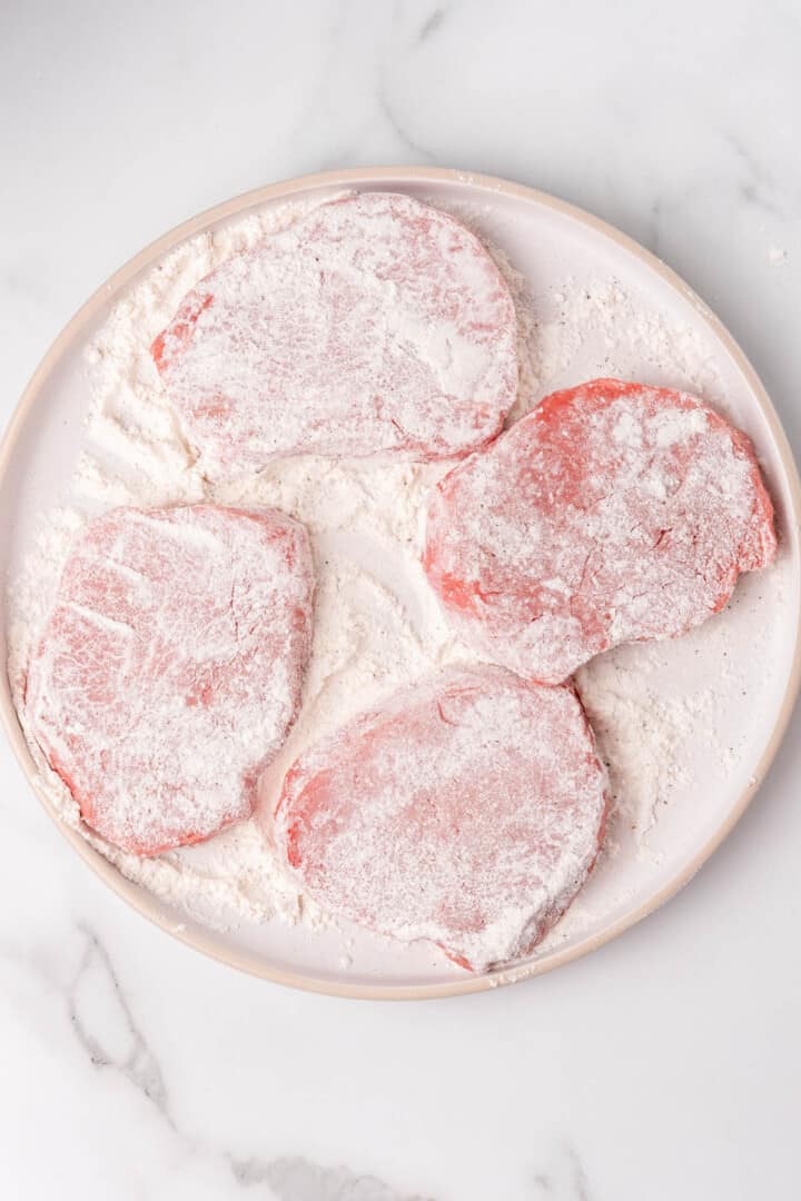 coating the steaks in flour.