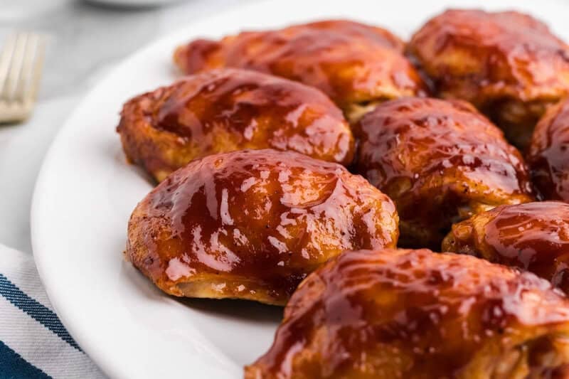 Baked BBQ Chicken Thighs on a white platter.