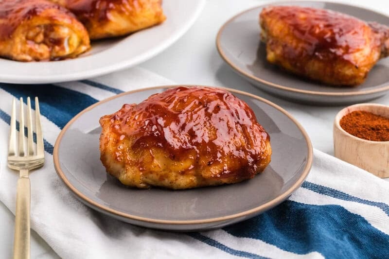 Baked BBQ Chicken Thighs on a gray plate.
