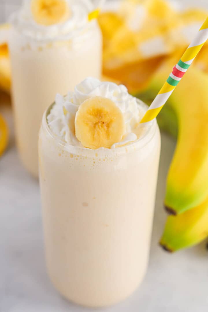 Banana Milkshake in glass with straw.