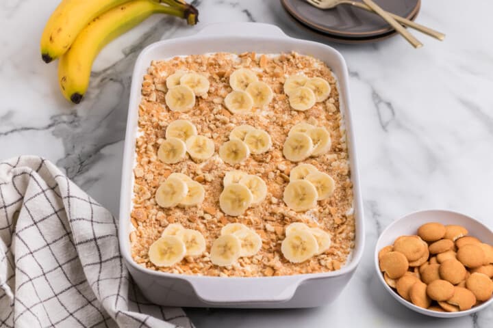 banana poke cake in a white dish.