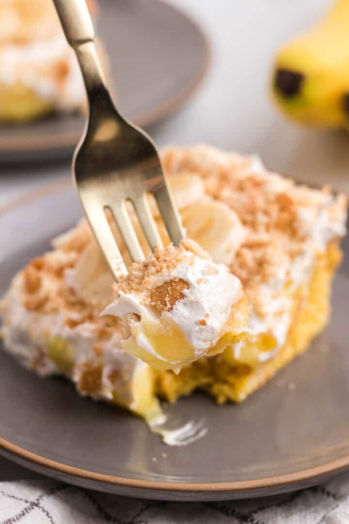 bite of banana pudding poke cake on fork.