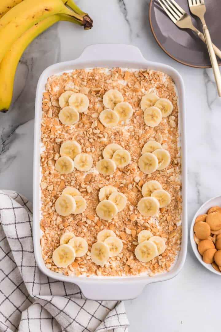 Banana Pudding Poke Cake in white cake pan.