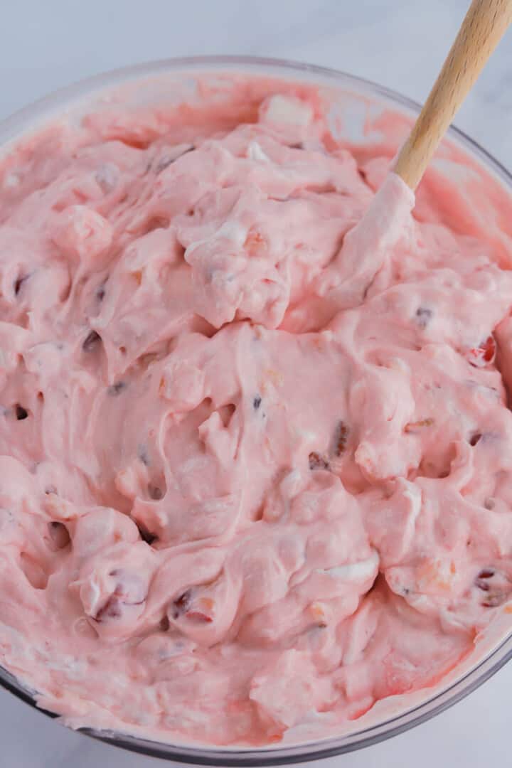 mixing the cherry fluff together in the bowl.