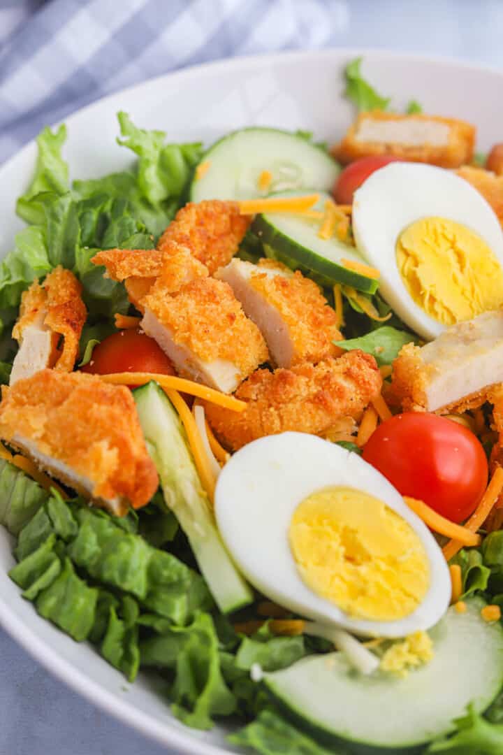 Crispy Chicken Salad in white salad bowl.