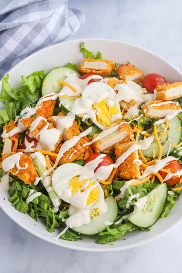 Ranch Dressing drizzled on top of the salad.