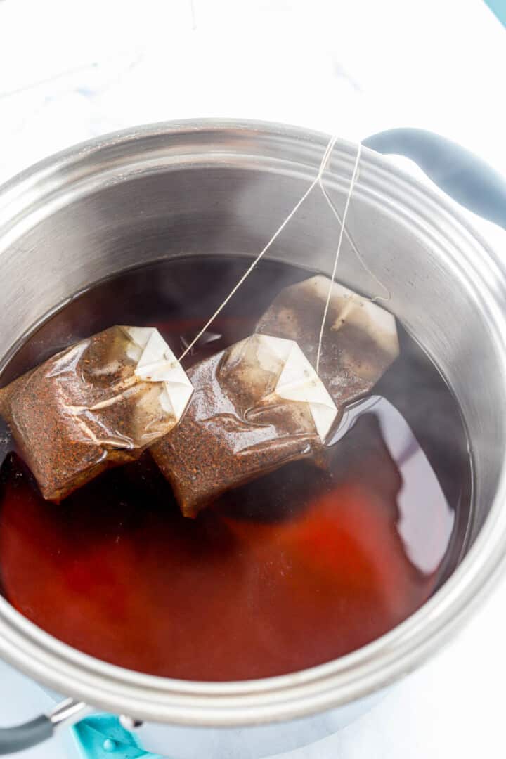 brewing the sweet tea in a large pot.