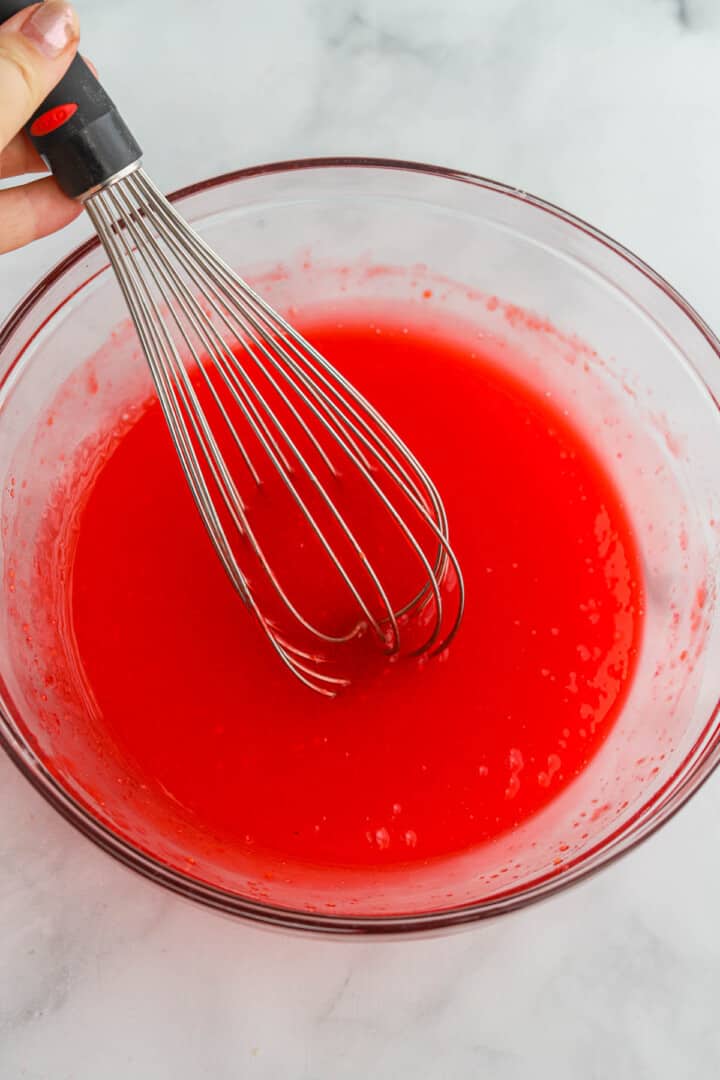 mixing the Jell-o with a whisk.