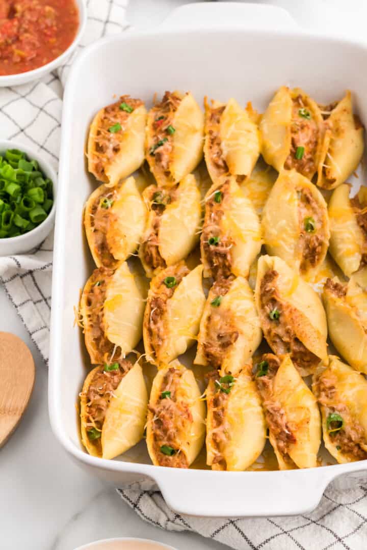 Taco Stuffed Shells in white casserole dish.