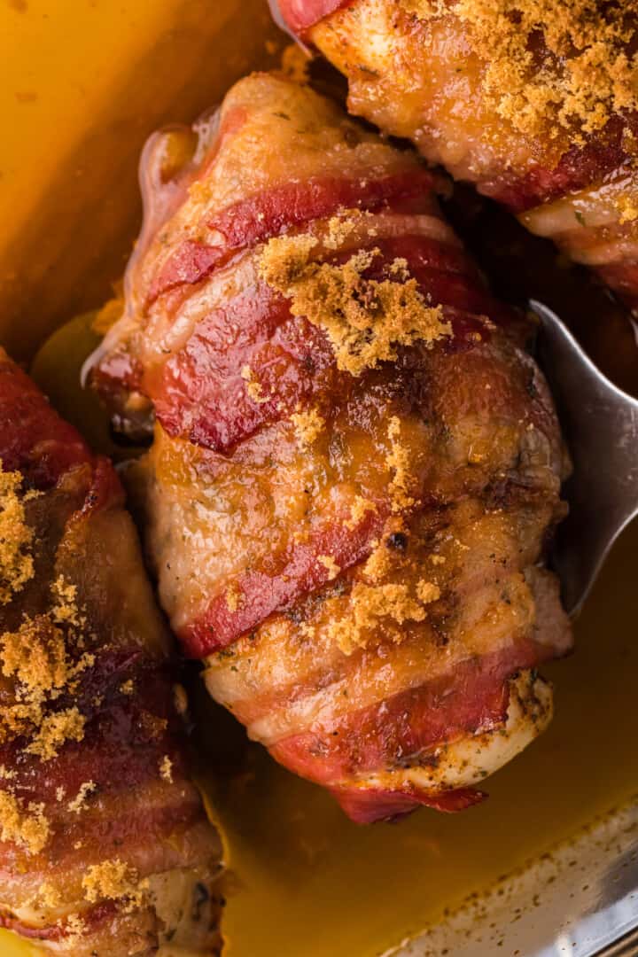 Bacon Wrapped Chicken closeup with spatula for serving.