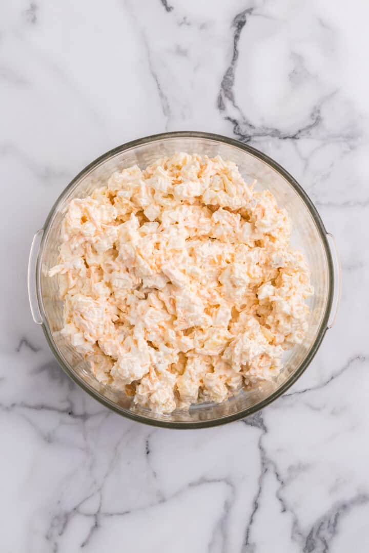 mixing all the ingredients together in a large bowl.