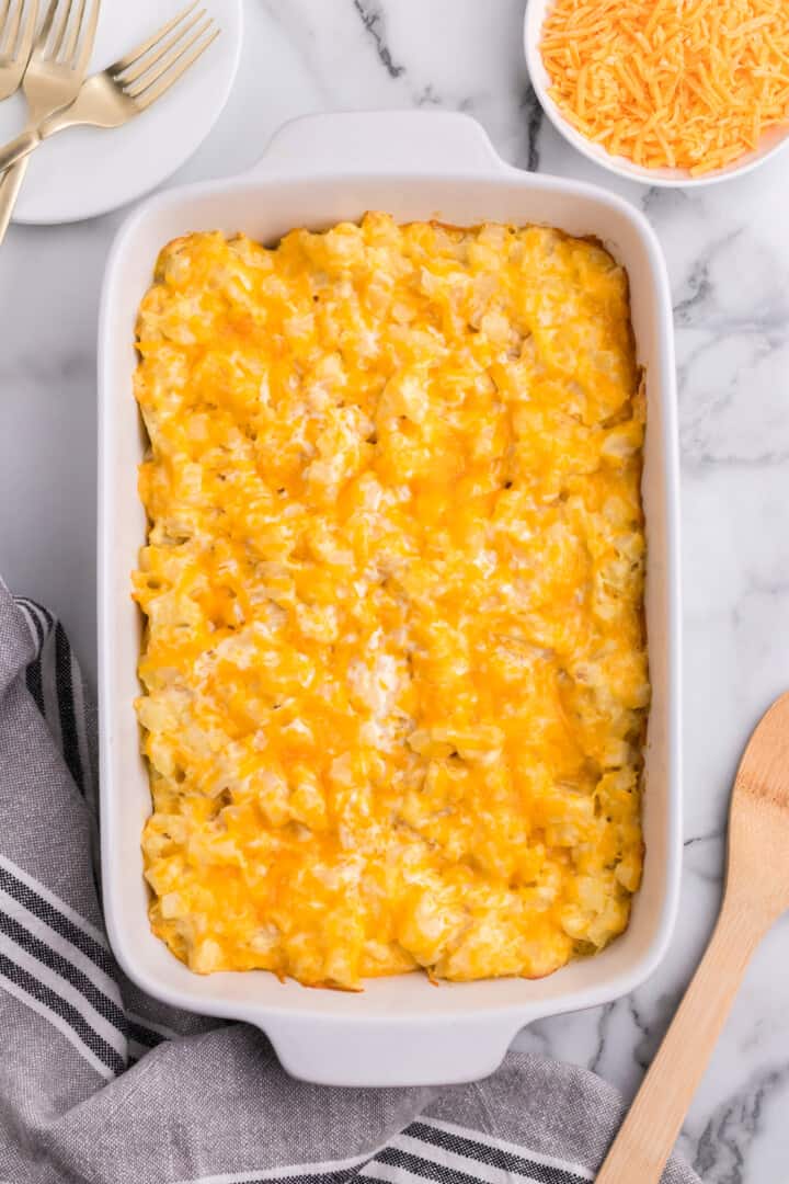 Cheesy Potato Casserole in white casserole dish.