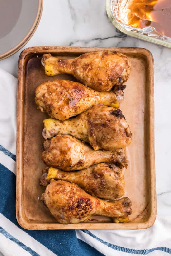 baked chicken drumsticks on a serving tray.