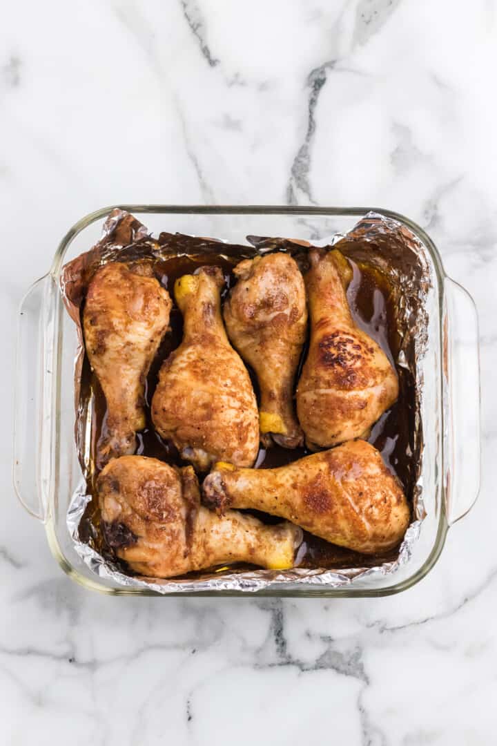 chicken drumsticks in baking dish.