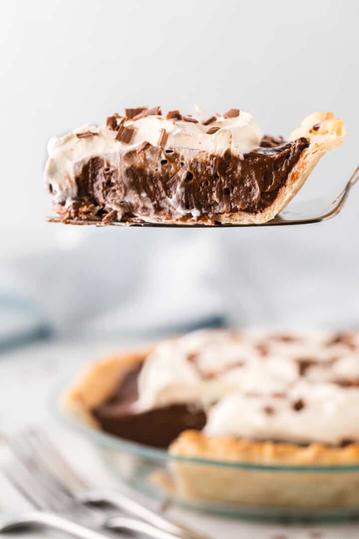 slice of pie on pie slicer in the air.