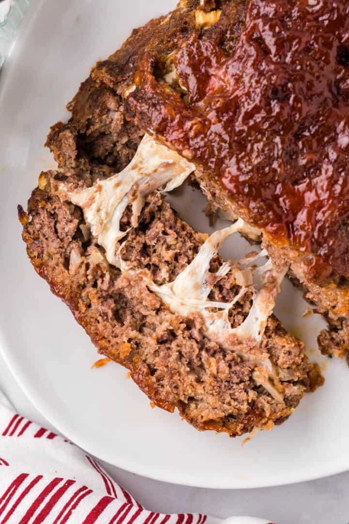 slicing the stuffed meatloaf.