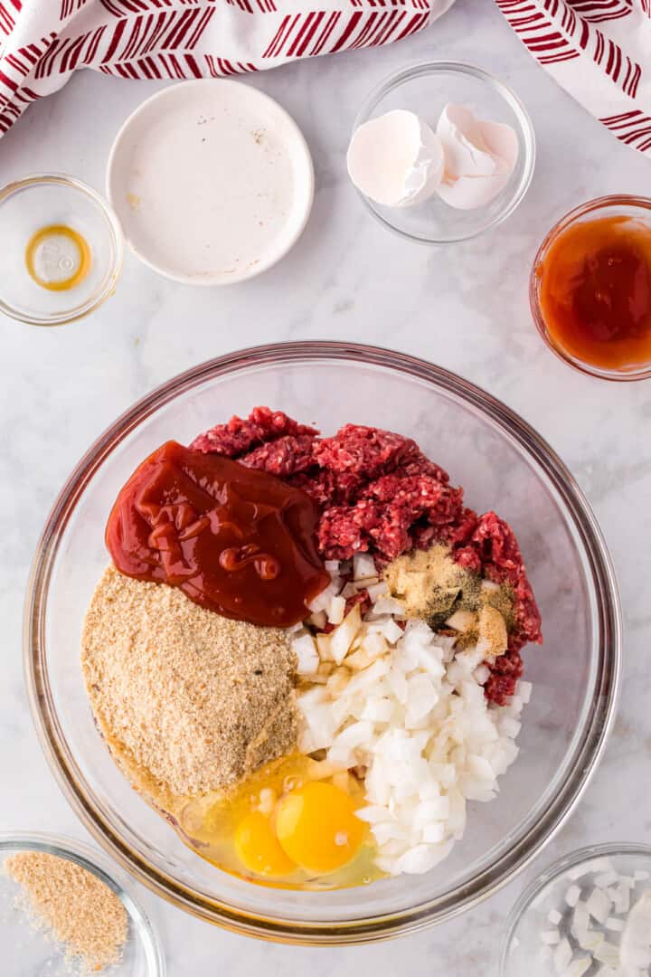 mixing the ingredients together for the meatloaf.