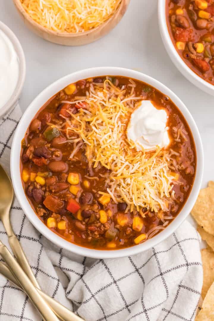 taco chili topped with cheese and sour cream.