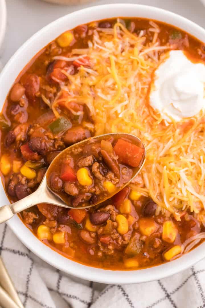 closeup of taco chili in bowl with spoon for eating.