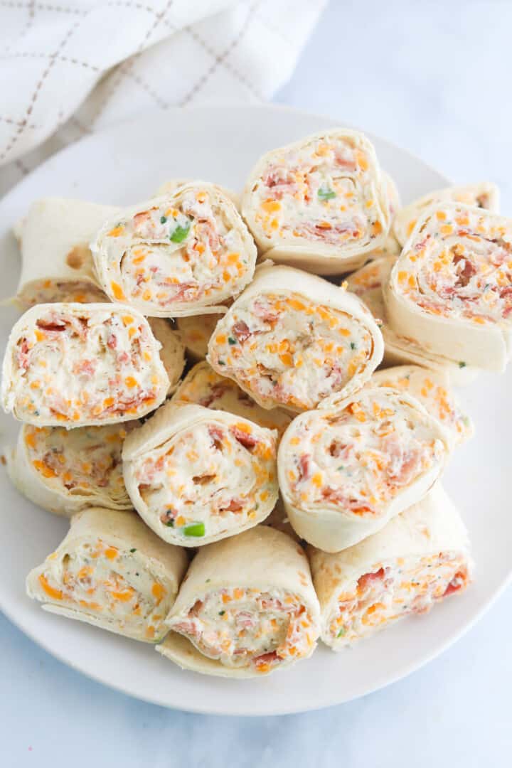 topview of pinwheels stacked on white plate.