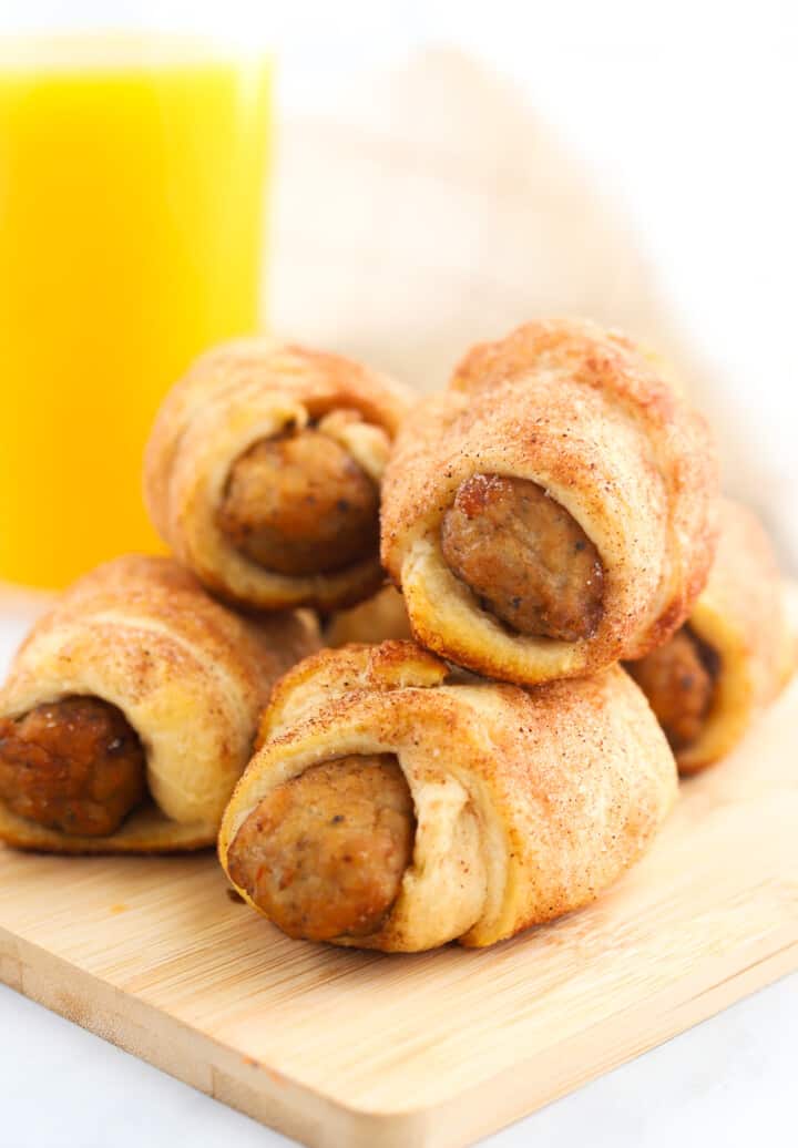 Breakfast Pigs in a Blanket on wooden serving board.