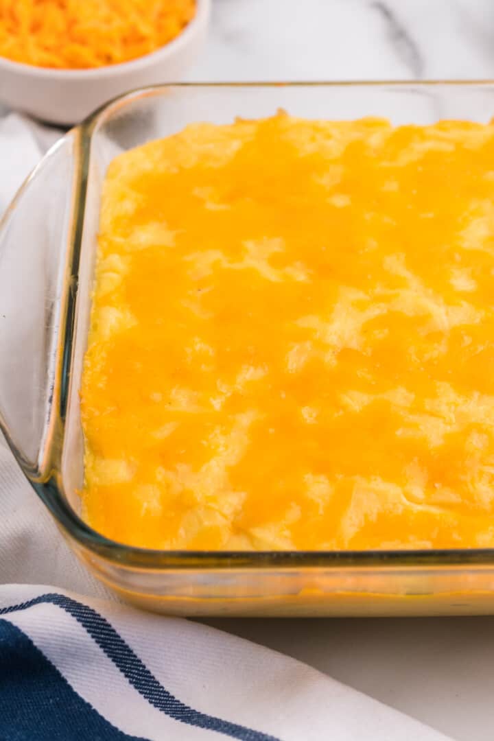 closeup of cheesy mashed potatoes in baking dishes.