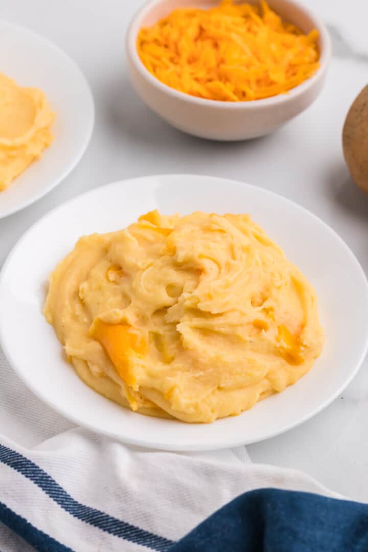 Cheesy Mashed Potatoes in white bowl.